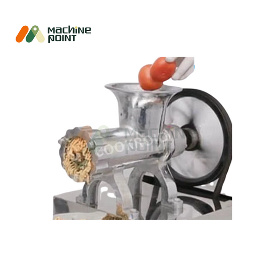 Chatani Machine without motor and stand – manual operation with tomato being fed into aluminum hopper for chutney grinding.