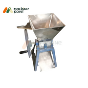 Angled top view of the Hand Chilly Cutter with a large stainless steel hopper and blue manual rotating handle.