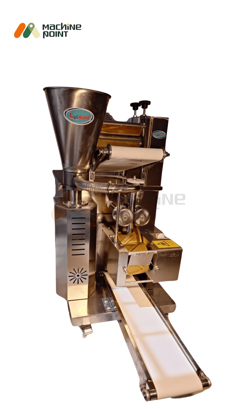 Close-up of high-speed samosa making machine showing stainless steel hopper and folding mechanism.

