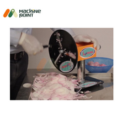 Close-up of the manual potato slicing machine neatly cutting onions into fine slices.