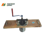 Front-facing view of the Manual Sev Maker featuring a red handle for easy rotation and dual side grips on a wooden platform.
