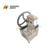 Top-angle view of Kadukas Bhuka Machine with attached grating tray and stainless steel body.