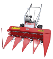 Side profile of Kamco Power Reaper KR120H operating in a paddy field, demonstrating cutting width and crop collection system